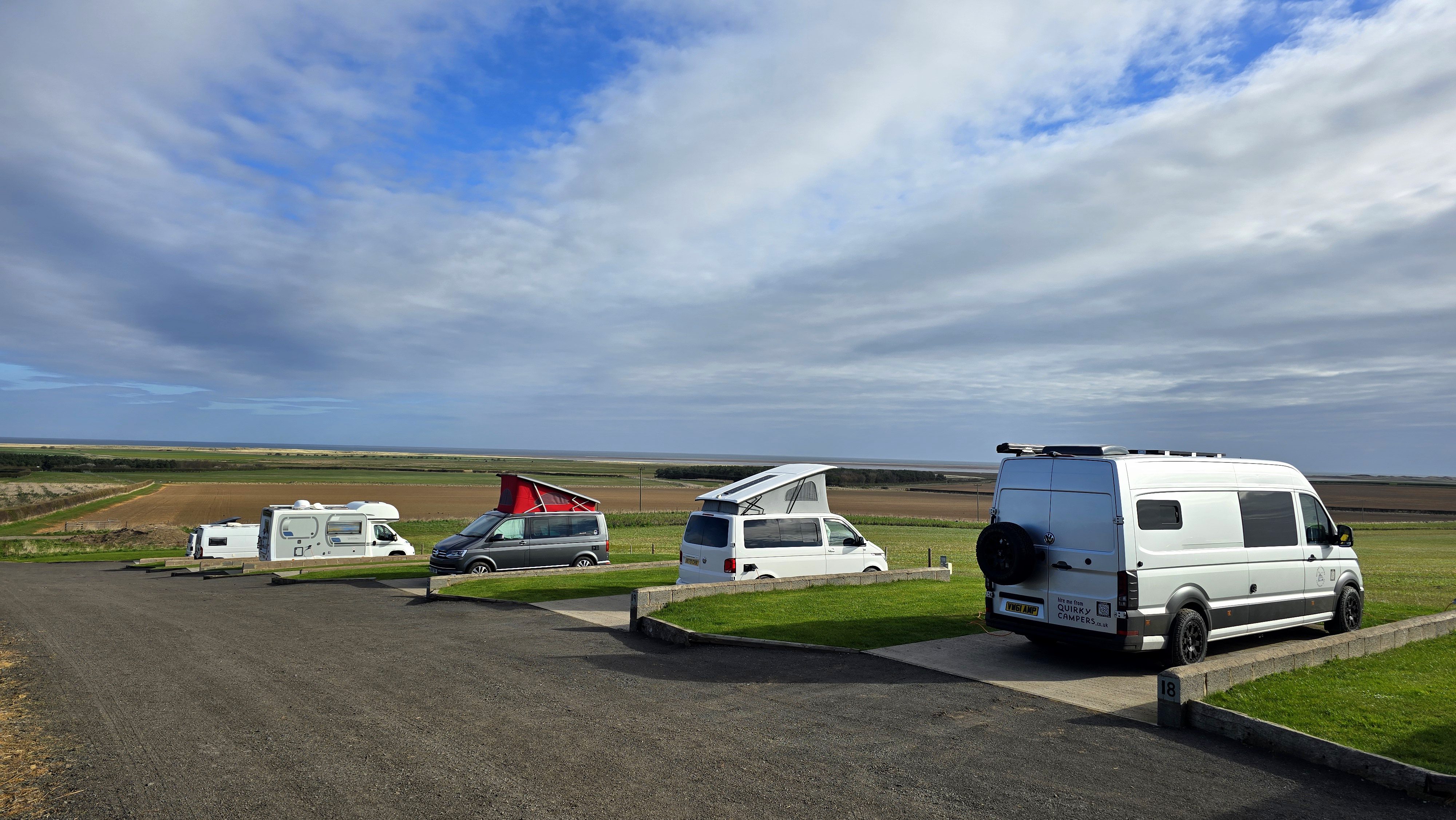 vans on H17 to H23 with a view of Goswick Beach